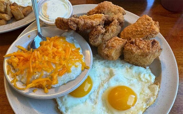 chicken tenders with fried eggs and sides at 43rd street deli breakfast house gainesville