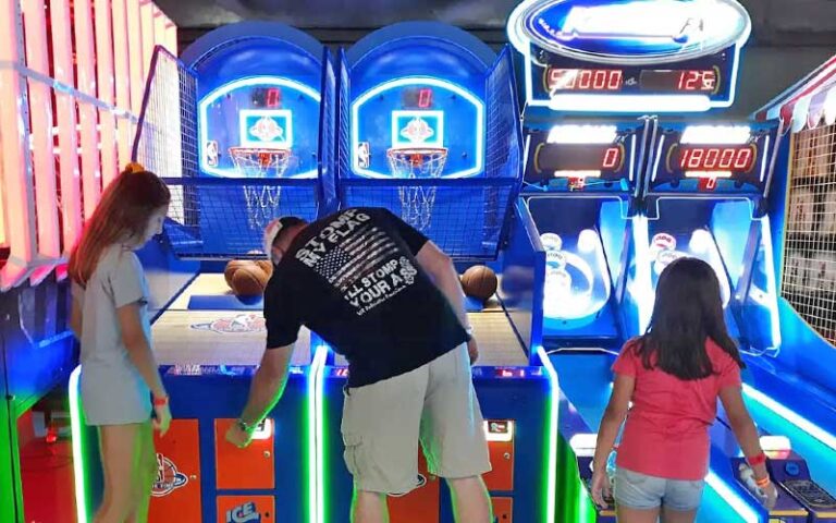 dad and kids playing arcade gallery games at flip factory zone gainesville