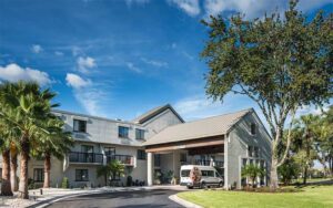 daytime hotel exterior with entrance and driveway at doubletree by hilton gainesville