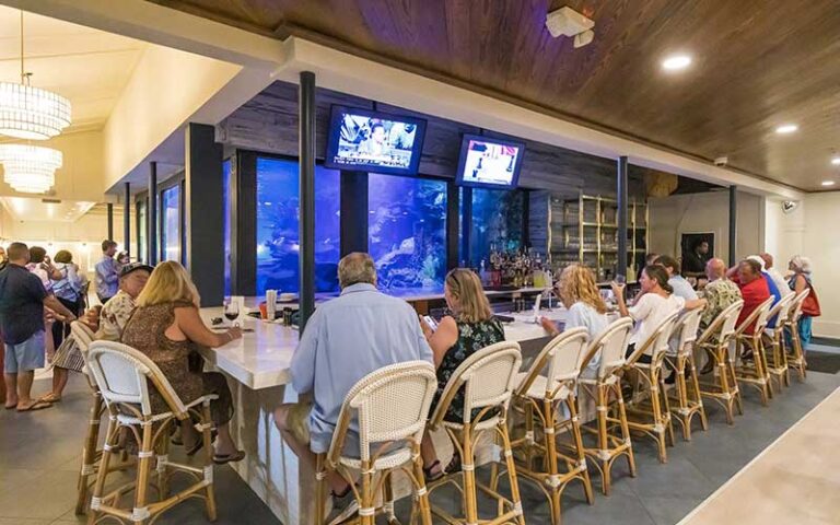 dining area with tables around large aquarium at saltwater grill panama city beach