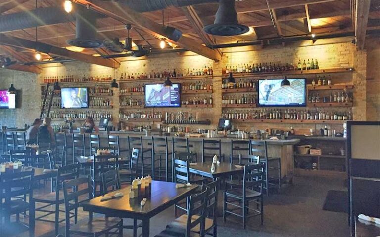 dining room with bar and tv screens at mojo hogtown bar b que gainesville