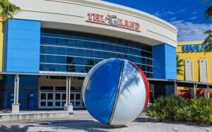 exterior of theater with giant beach ball sculpture at the grand pier park panama city beach