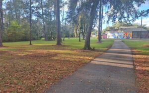 forested walkway leading to racquetball courts at tom petty park gainesville