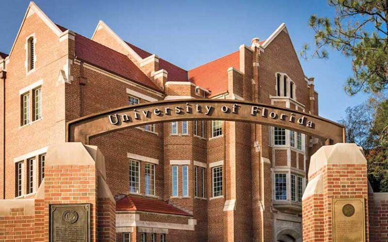 gate archway with sign and red brick buildings at university of florida gainesville