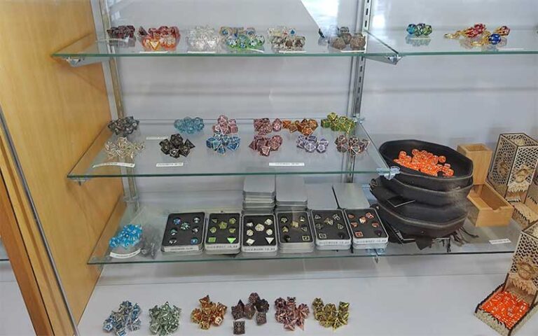 glass case with assorted gaming dice at punkouter games gainesville