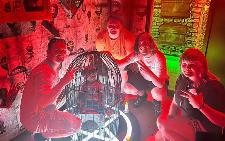 group in red lighting with caged doll prop at fear at the pier panama city beach