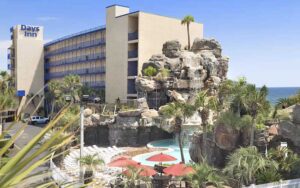 high rise hotel with pool area below at days inn by wyndham panama city beach ocean front