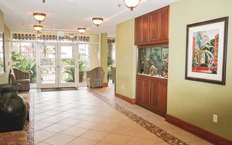 hotel lobby with seating and aquarium at shores of panama city beach