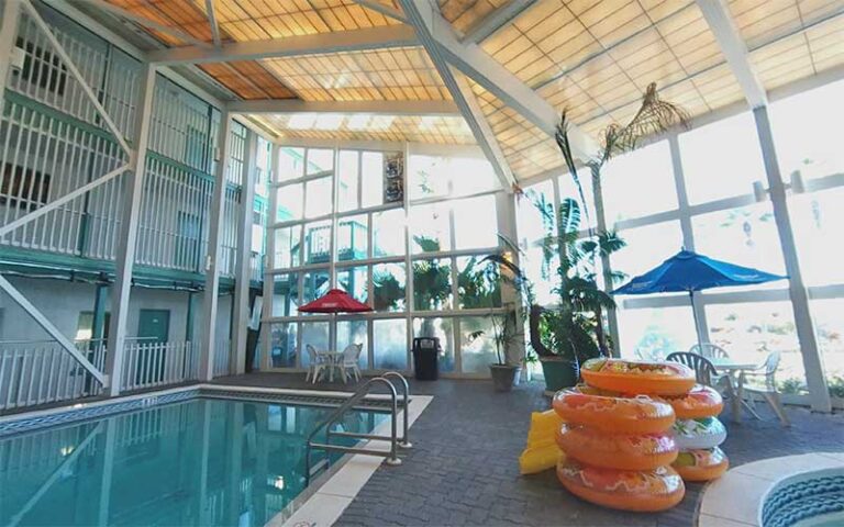 indoor pool and lazy river with inner tubes at the sandpiper beacon beach resort panama city beach