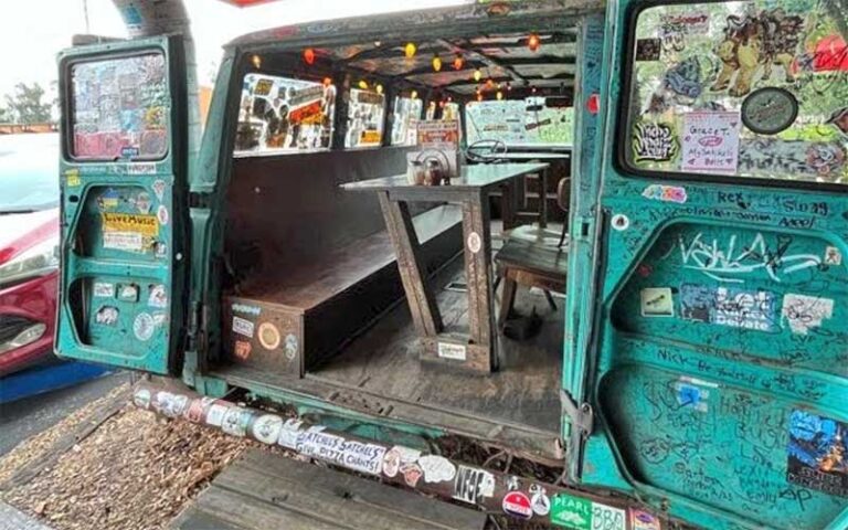 inside of minibus with dining table at satchels pizza gainesville