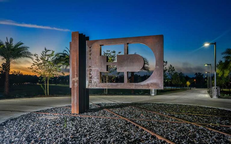 iron sculpture sign with sunset at depot park gainesville