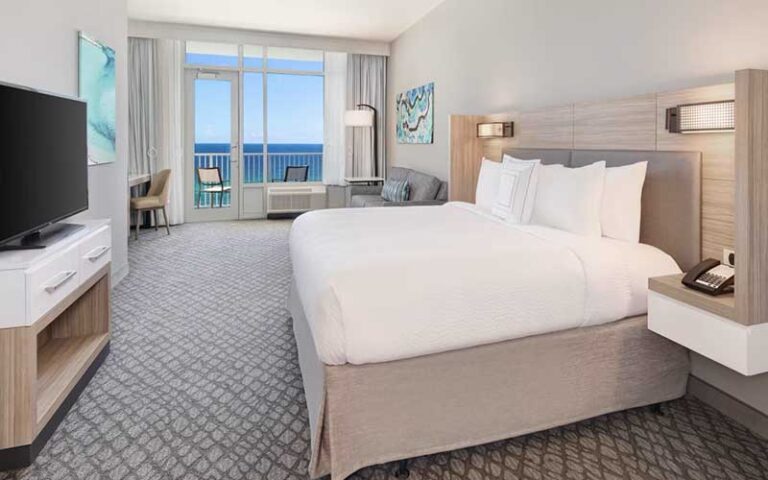 king size bed suite with balcony at springhill suites panama city beach beachfront