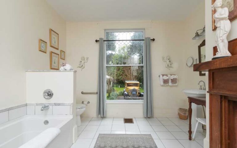 large bathroom interior with view of yard and model t car at herlong mansion micanopy gainesville