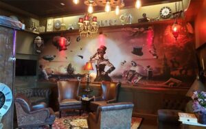 lounge area with leather chairs and wall mural at escapology gainesville