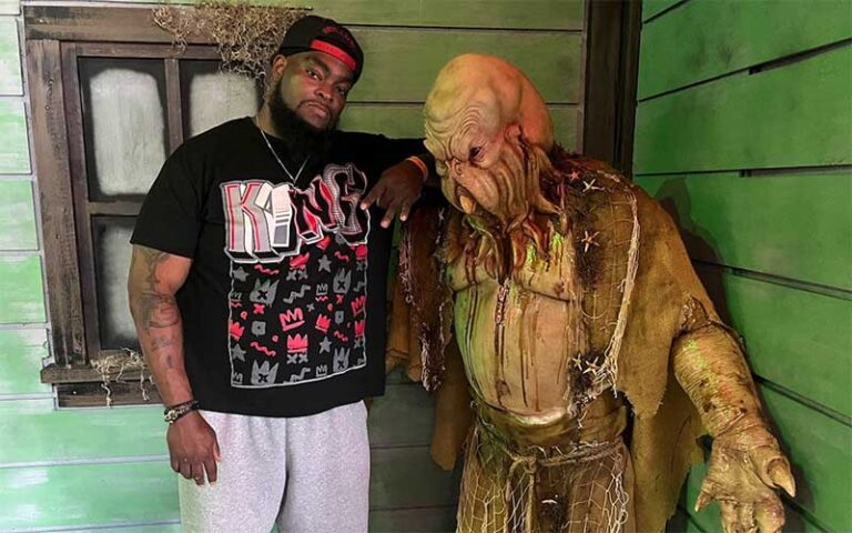 man posing with swamp creature prop at fear at the pier panama city beach