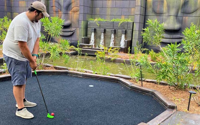 man putting on course with waterfalls at swampy jacks wongo adventure panama city beach