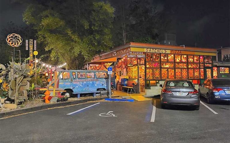 night exterior of restaurant with minibus in garden at satchels pizza gainesville