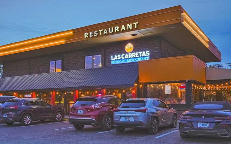 night exterior of restaurant with parked car at las carretas mexican restaurant gainesville