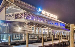 night exterior view from marina dock of restaurant at the grand marlin panama city beach