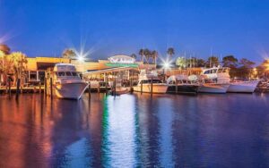 night view from lagoon of building with marina boats at capt andersons restaurant waterfront market panama city beach