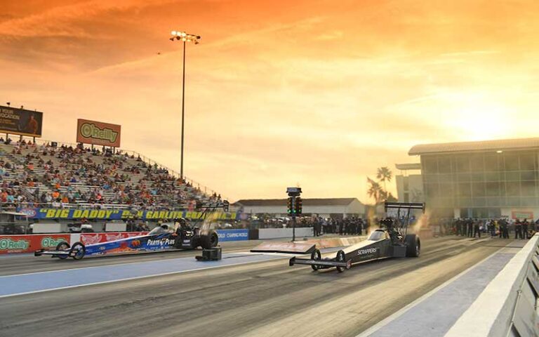 pair of competing dragsters on track with sunset sky at gainesville raceway