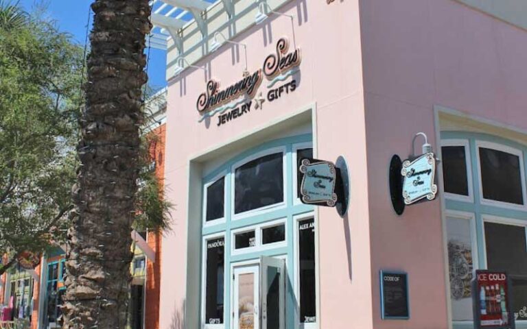 pink corner store front with signs and palm at shimmering seas jewelry gifts panama city beach