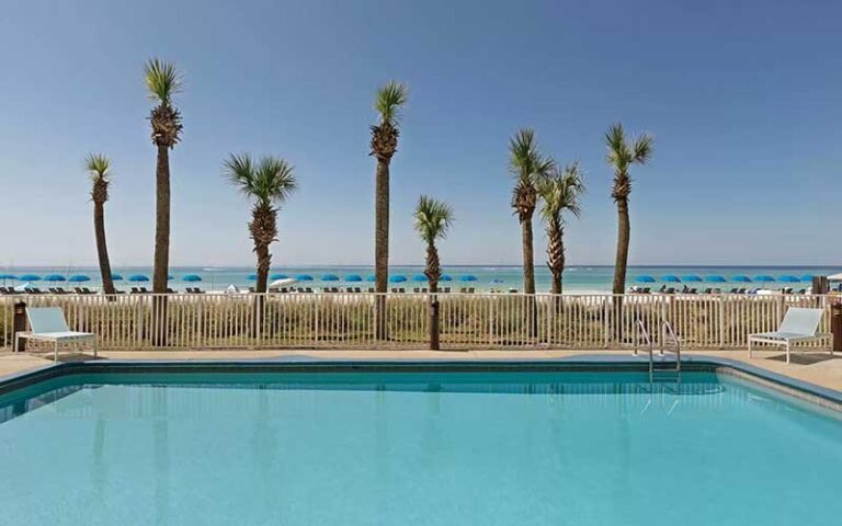 pool deck with beach and palms at radisson hotel panama city beach oceanfront