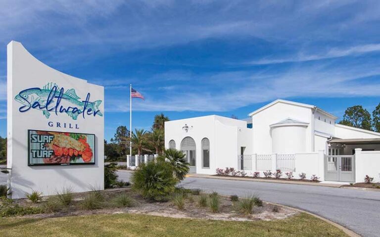 restaurant exterior with sign and blue sky at saltwater grill panama city beach