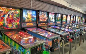 row of lit up pinball machines at bragging rights amusements gainesville