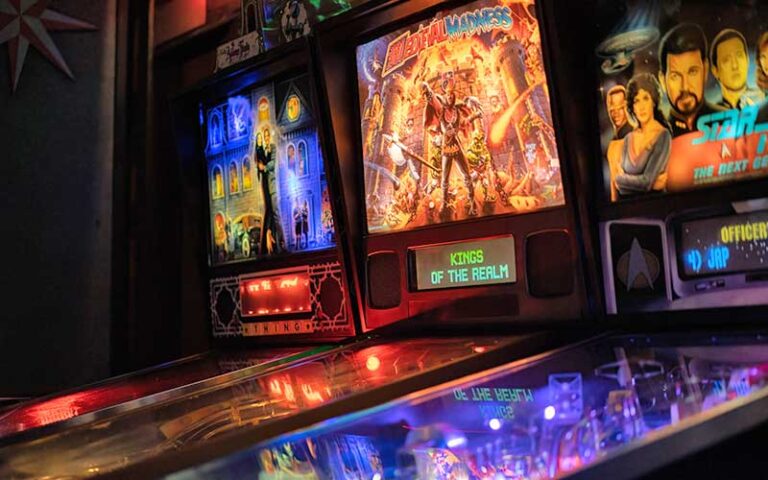 row of pinball machines lit up at arcade bar gainesville