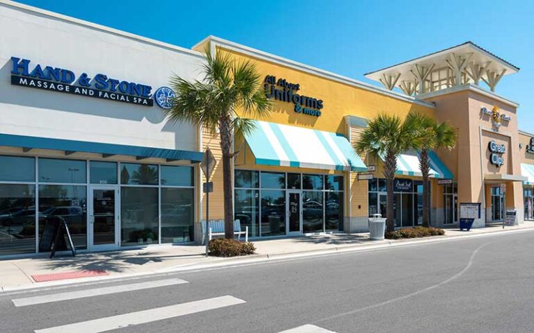 row of stores with parking at pier park north panama city beach