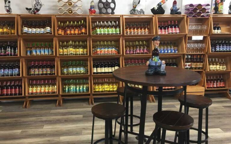 seating area with wine bottle shelves at panama city beach winery