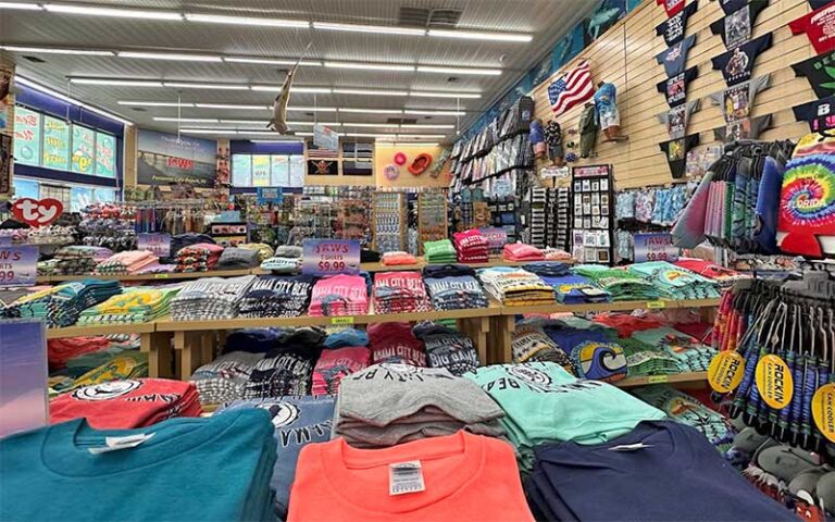 shelves and tables of t shirts at jaws souvenirs panama city beach