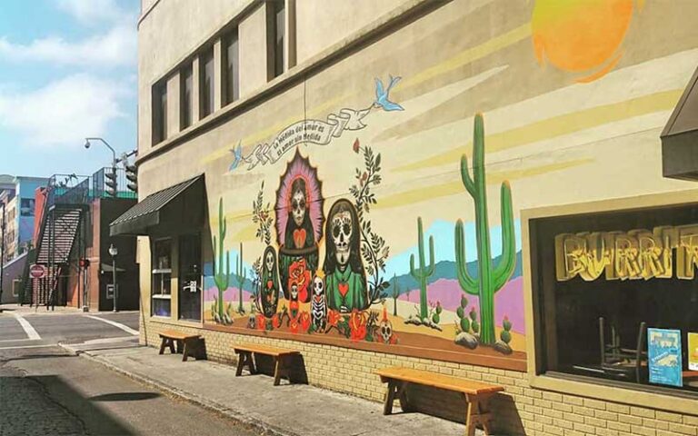 sidewalk seating with dia de los muertos mural at flacos gainesville