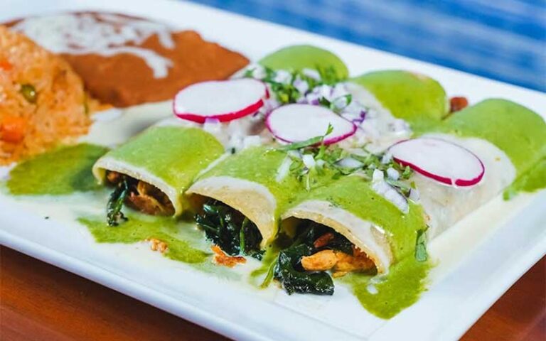 spinach tamales on plate with sides at las carretas mexican restaurant gainesville