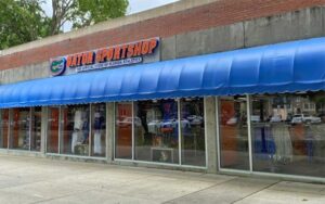 storefront shop with awning and sign at official gator sports shop gainesville