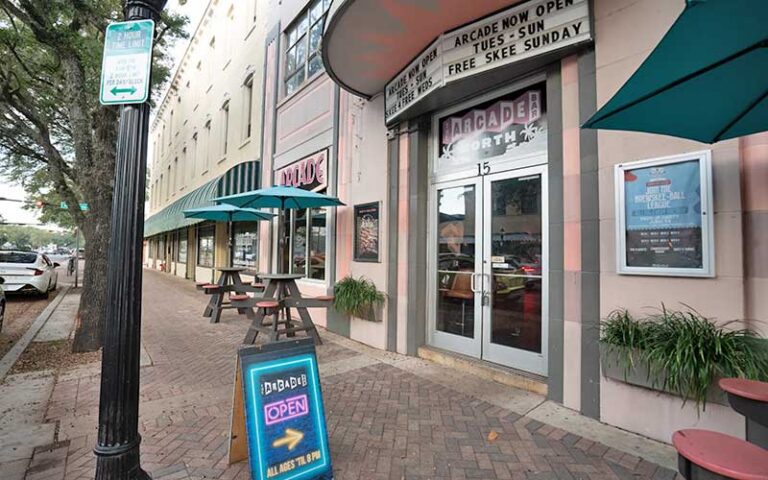 street sidewalk entrance with sign at arcade bar gainesville