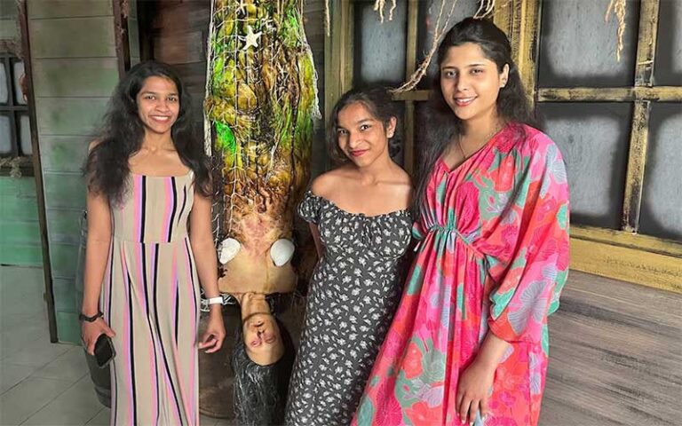 three ladies posing with hanging corpse prop at fear at the pier panama city beach