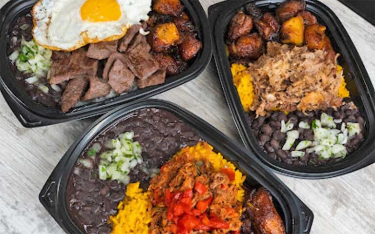 three trays of dinner entrees at mi apa latin cafe gainesville