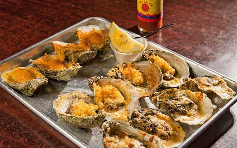 tray of raw oysters with hot sauce at dat cajun place cafe panama city beach