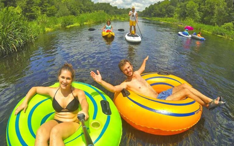 tubers and paddleboarders on river at ichetucknee springs state park gainesville