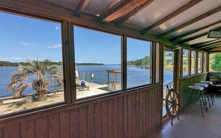 view of dining area windows with river dock at boon docks panama city beach