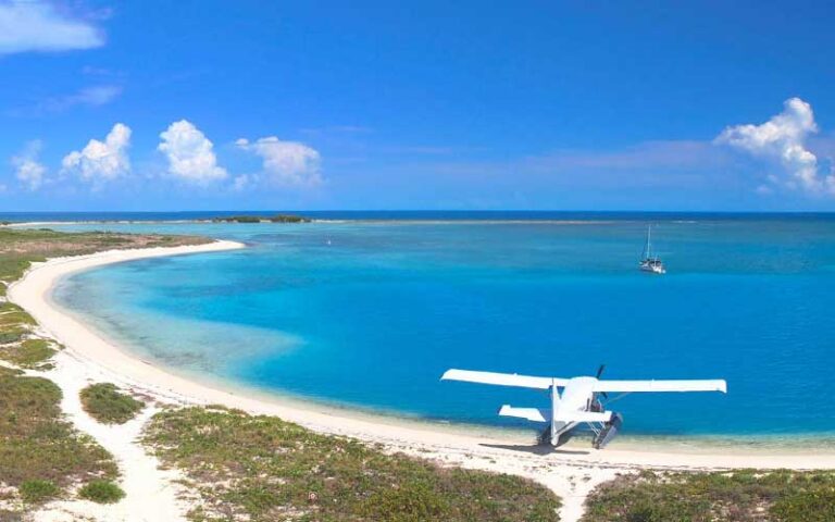 aerial from fort of curving beach with plane and boat at key west seaplane adventures