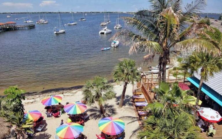 aerial view of beach area with dining tables and boats in harbor at squid lips melbourne