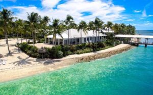 aerial view of island beach with cottage and pier at sunset key cottages key west