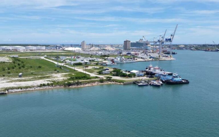 aerial view of port with cargo cranes and tug boats at port canaveral space coast