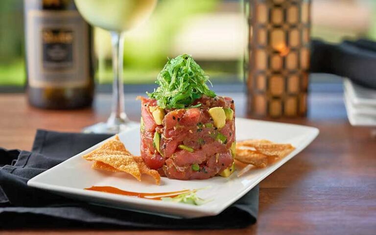 ahi salad with garnish and wine at river rocks rockledge