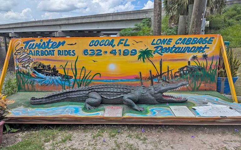 alligator statue with airboat sign and underpass at lone cabbage fish camp cocoa