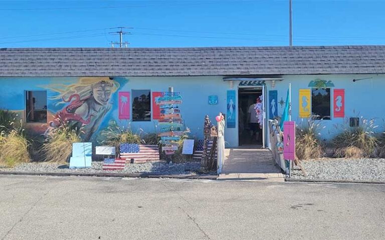 blue beachy shop exterior with art at pelican cove gifts souvenirs cocoa beach