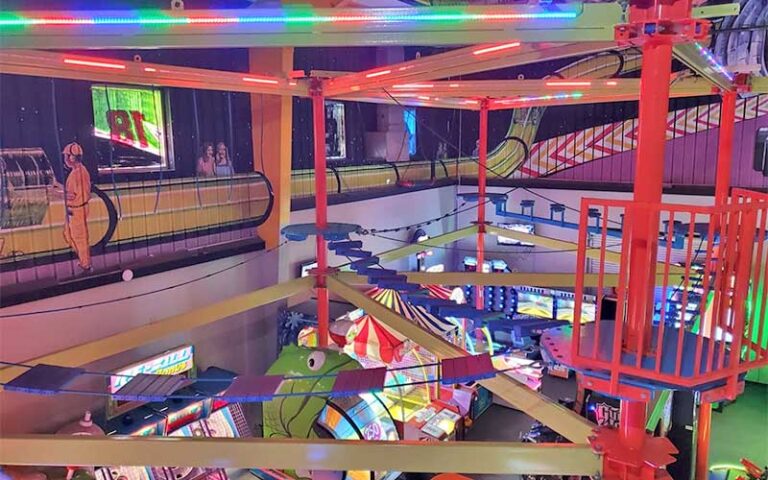 colorful indoor arcade with ropes course above at andretti thrill park melbourne